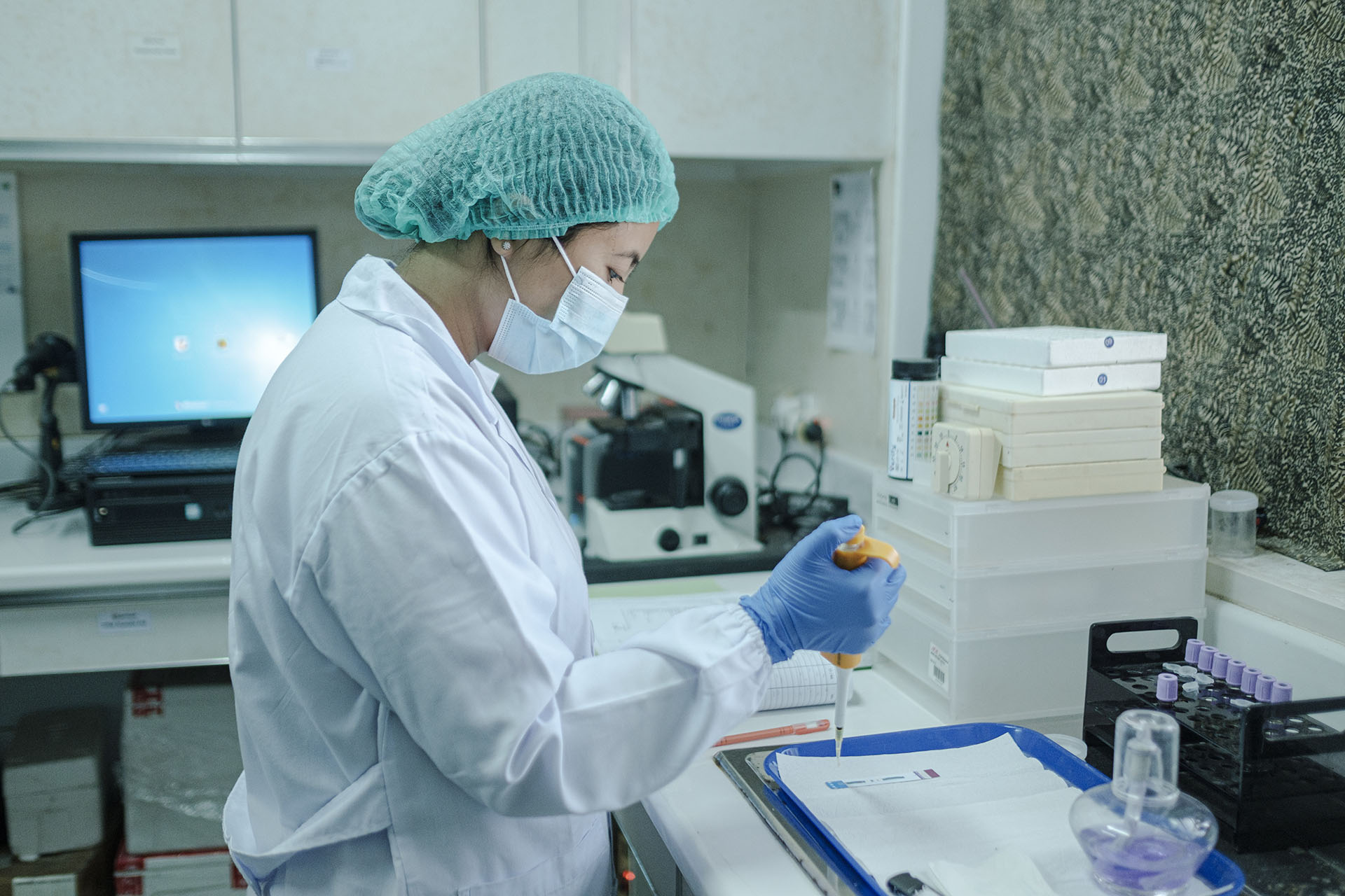 An employee carrying out an HIV test with the lab equipment purchased by Mitra Prodin